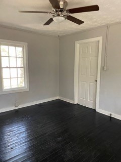 1429 25th Street Columbus, GA 31901 - Photo 8 of 17 an empty room with wooden floor fan and windows