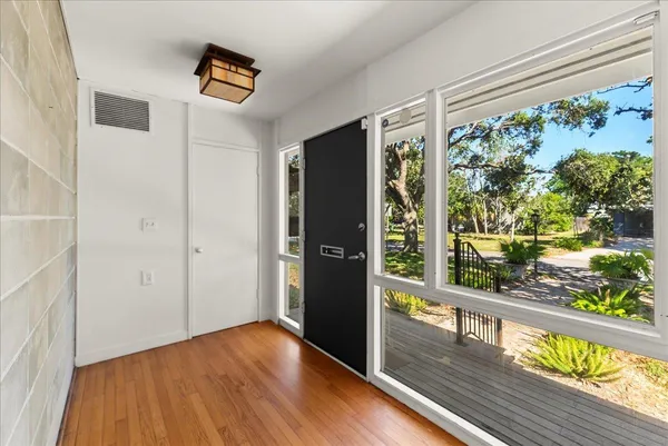 a view of a floor to ceiling window with wooden floor
