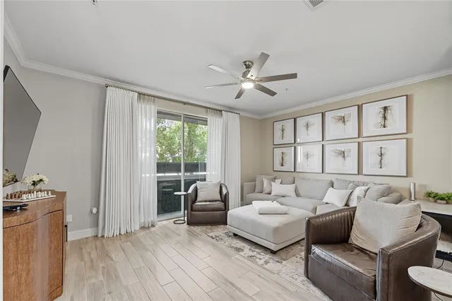 a bedroom with furniture and a large window