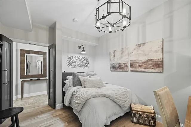 a bedroom with a bed and wooden floor