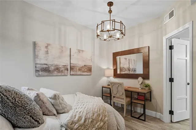 a bedroom with a bed and a chandelier