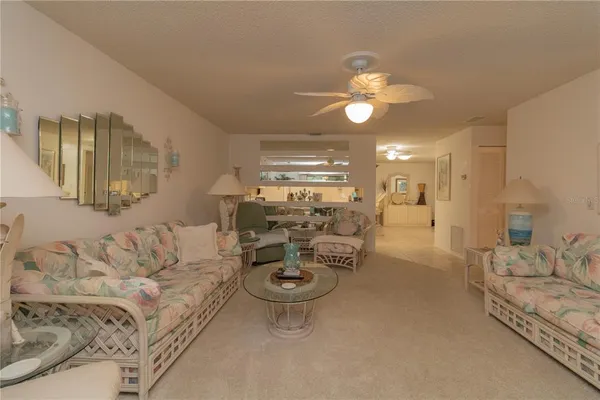 a living room with furniture a lamp and a chandelier