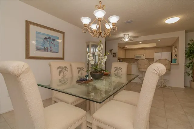 a view of a dining room with furniture and chandelier