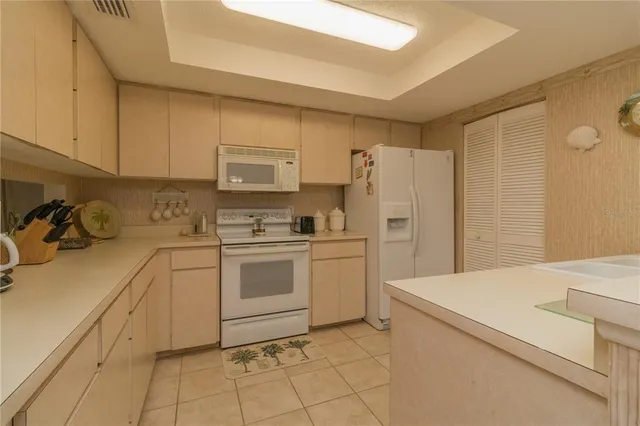 a kitchen with a white cabinets and white appliances