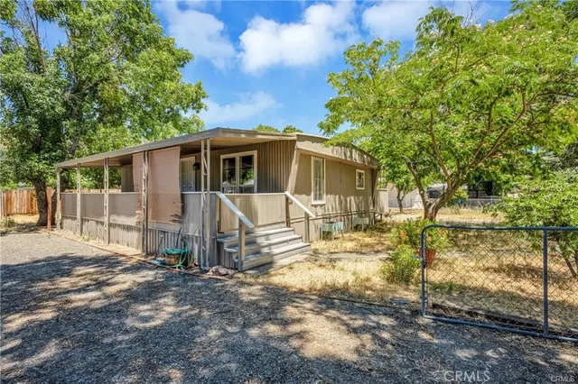 a view of a house with backyard and sitting area