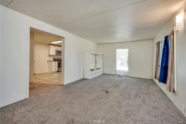 an empty room with windows and closet