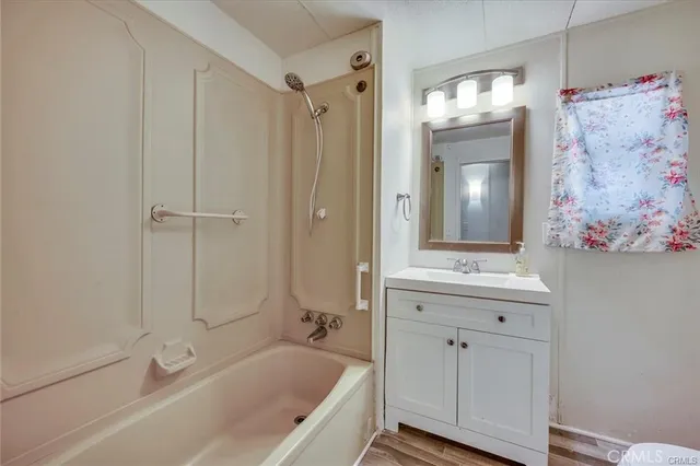 a bathroom with a tub a sink and mirrors