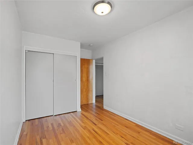a view of an empty room and wooden floor