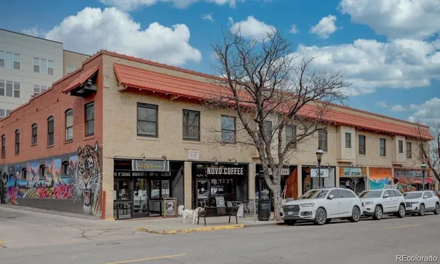 a car parked in front of a white building