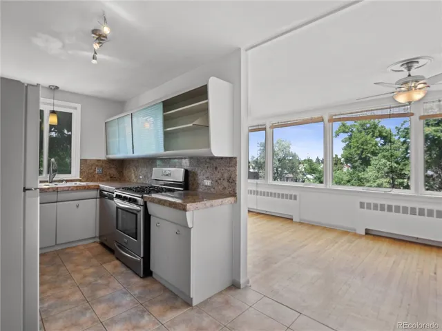 a kitchen with a stove a sink and a refrigerator