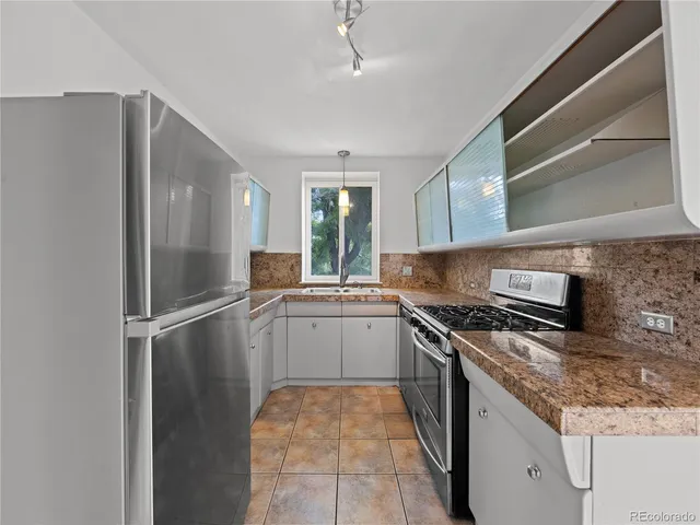 a kitchen with a sink stove and refrigerator