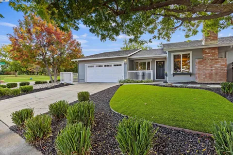 a view of a house with a swimming pool and a yard