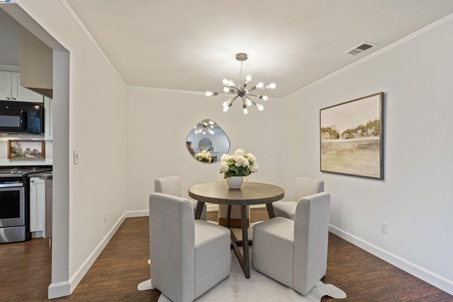 a kitchen with granite countertop cabinets stainless steel appliances and wooden floor