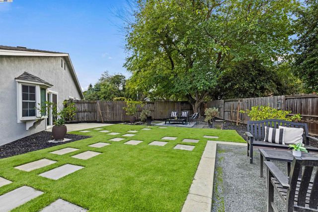 a view of a swimming pool with a patio and a garden