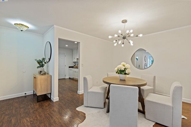 a dining room with furniture and chandelier