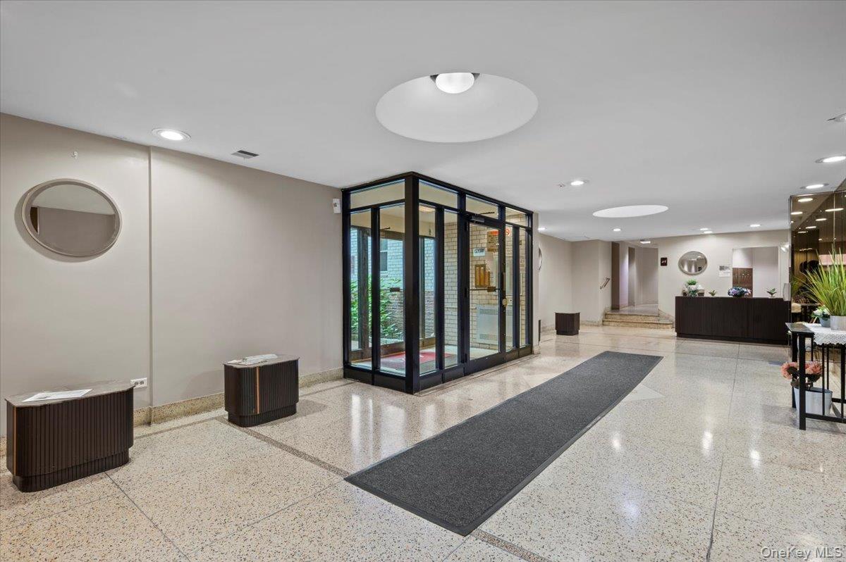 4320 Van Cortlandt Park East, Unit 4C Bronx, NY 10470 - Photo 18 of 21 a living room with furniture a mirror and a ceiling fan