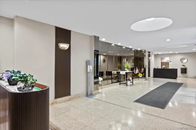 a view of a dining room with furniture and a potted plant