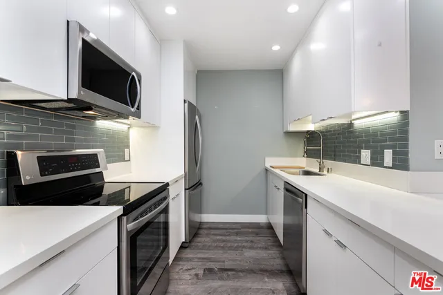 a kitchen with a sink and a stove top oven