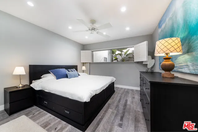 a bedroom with a bed and a night stand