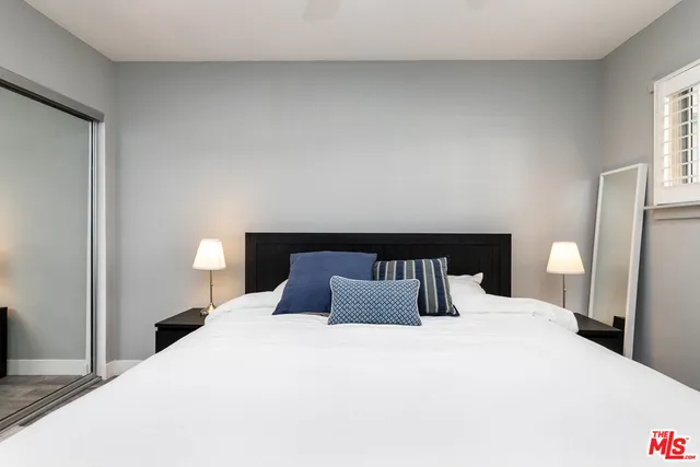 a bedroom with bed and a chandelier