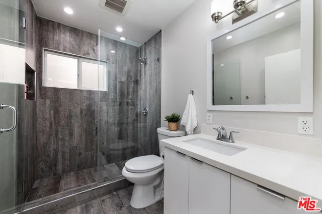 a bathroom with a shower and a sink