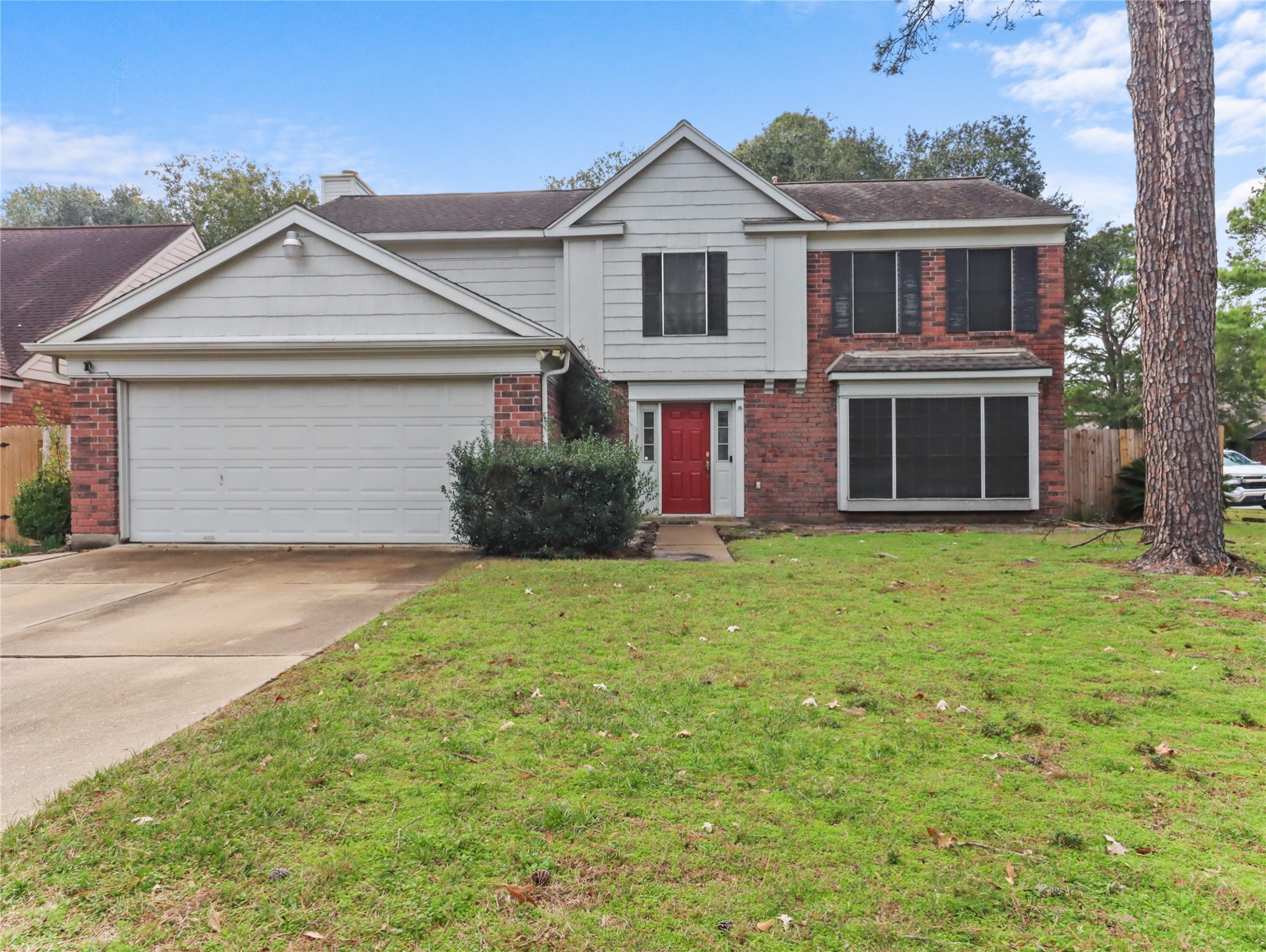 a front view of house with yard and garage