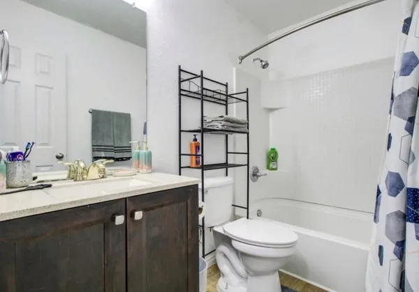 a bathroom with a sink toilet vanity and shower