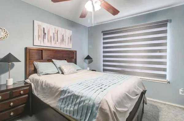 a bedroom with a bed and a chandelier