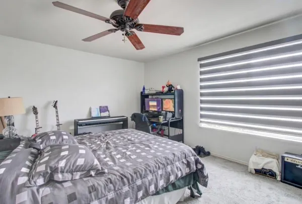 a bedroom with a bed and a tv