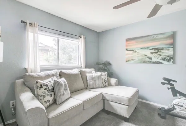 a living room with furniture and a large window