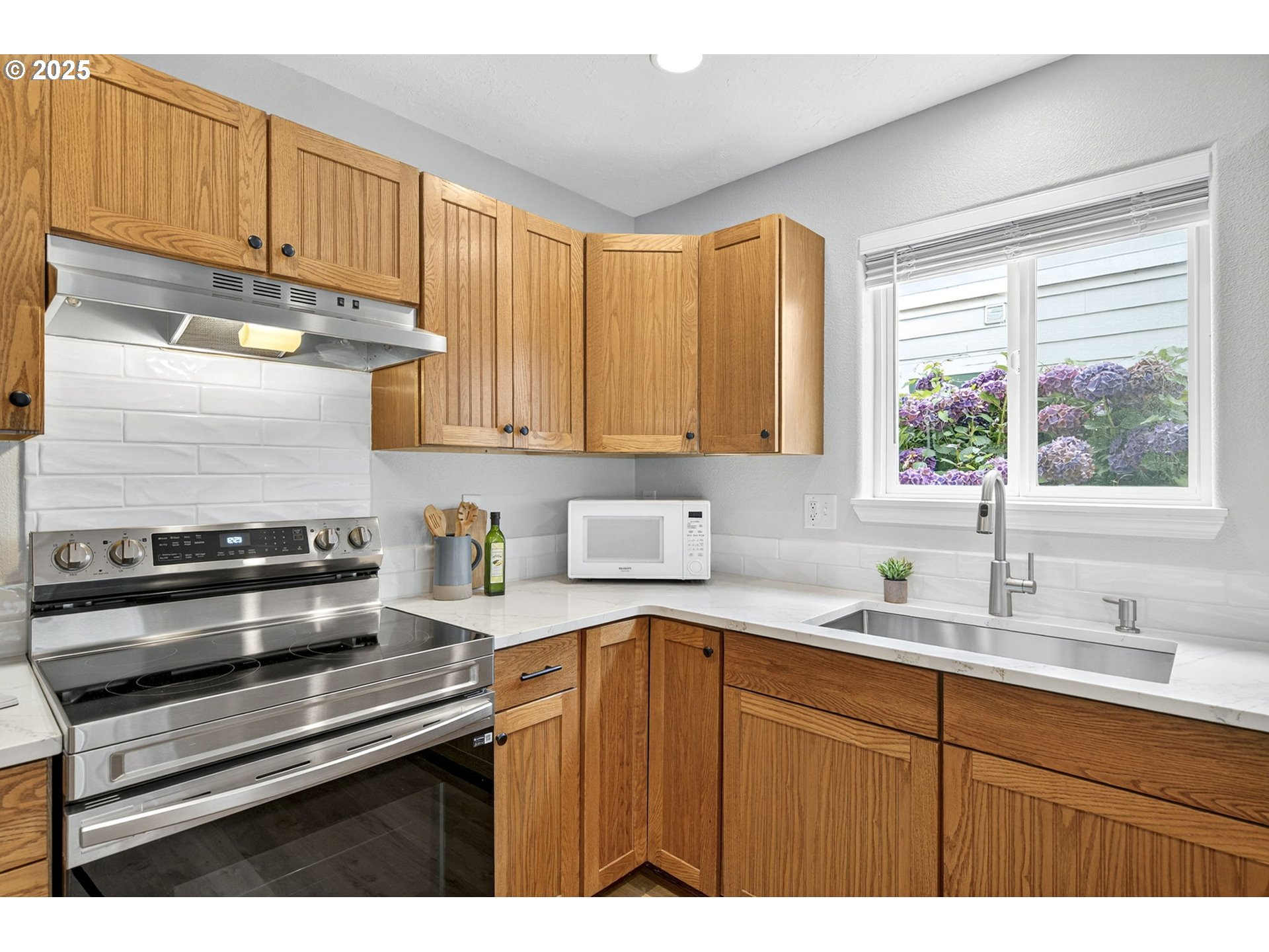 929 Northwest Spring Street Newport, OR 97365 - Photo 17 of 46 a kitchen with a sink stove and cabinets