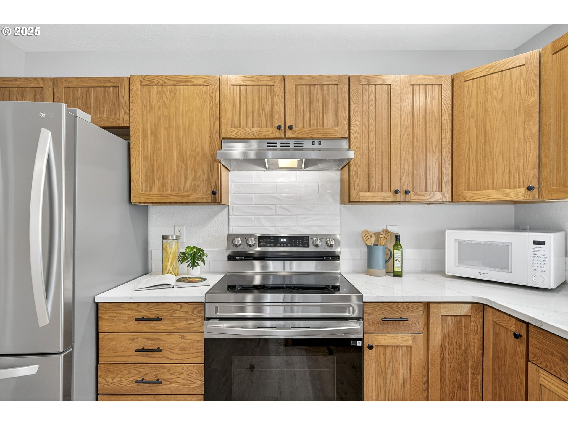 929 Northwest Spring Street Newport, OR 97365 - Photo 18 of 46 a kitchen with stainless steel appliances granite countertop a refrigerator sink and cabinets