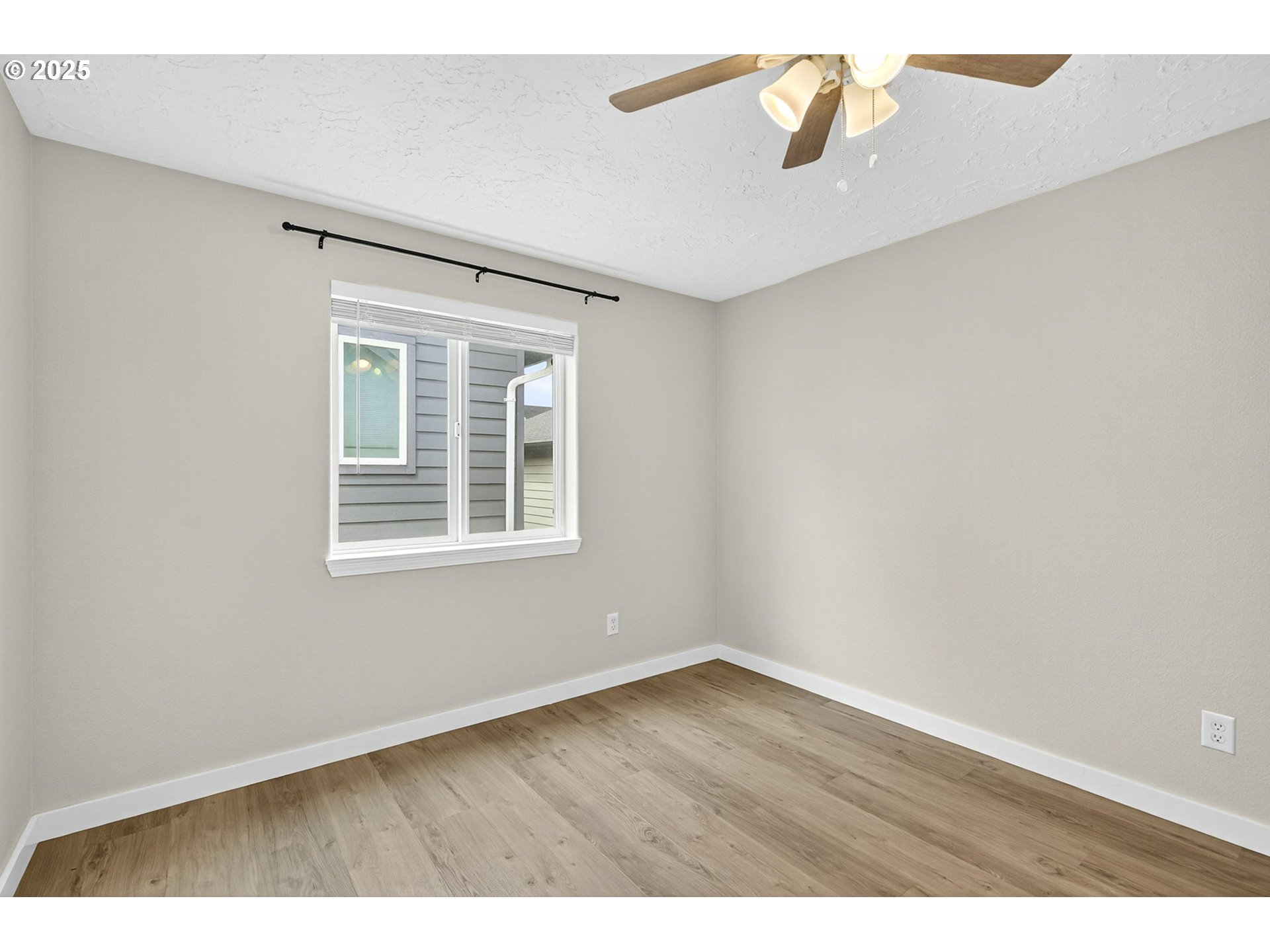 929 Northwest Spring Street Newport, OR 97365 - Photo 29 of 46 a view of an empty room with wooden floor and a window