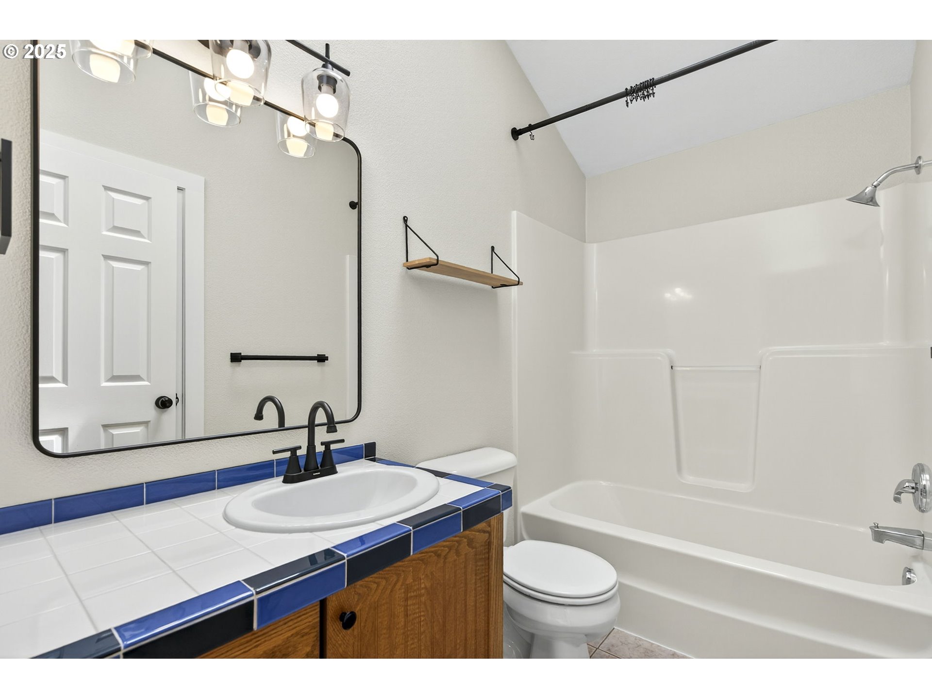 929 Northwest Spring Street Newport, OR 97365 - Photo 30 of 46 a bathroom with a sink a toilet a mirror and shower