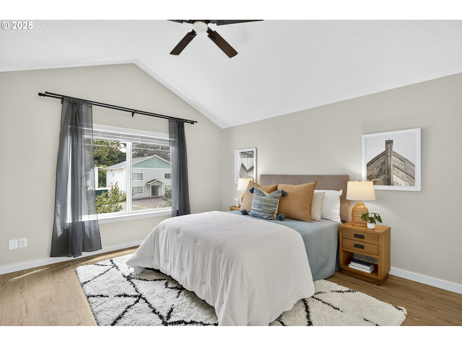 929 Northwest Spring Street Newport, OR 97365 - Photo 32 of 46 a bedroom with a bed a dresser and next to a window