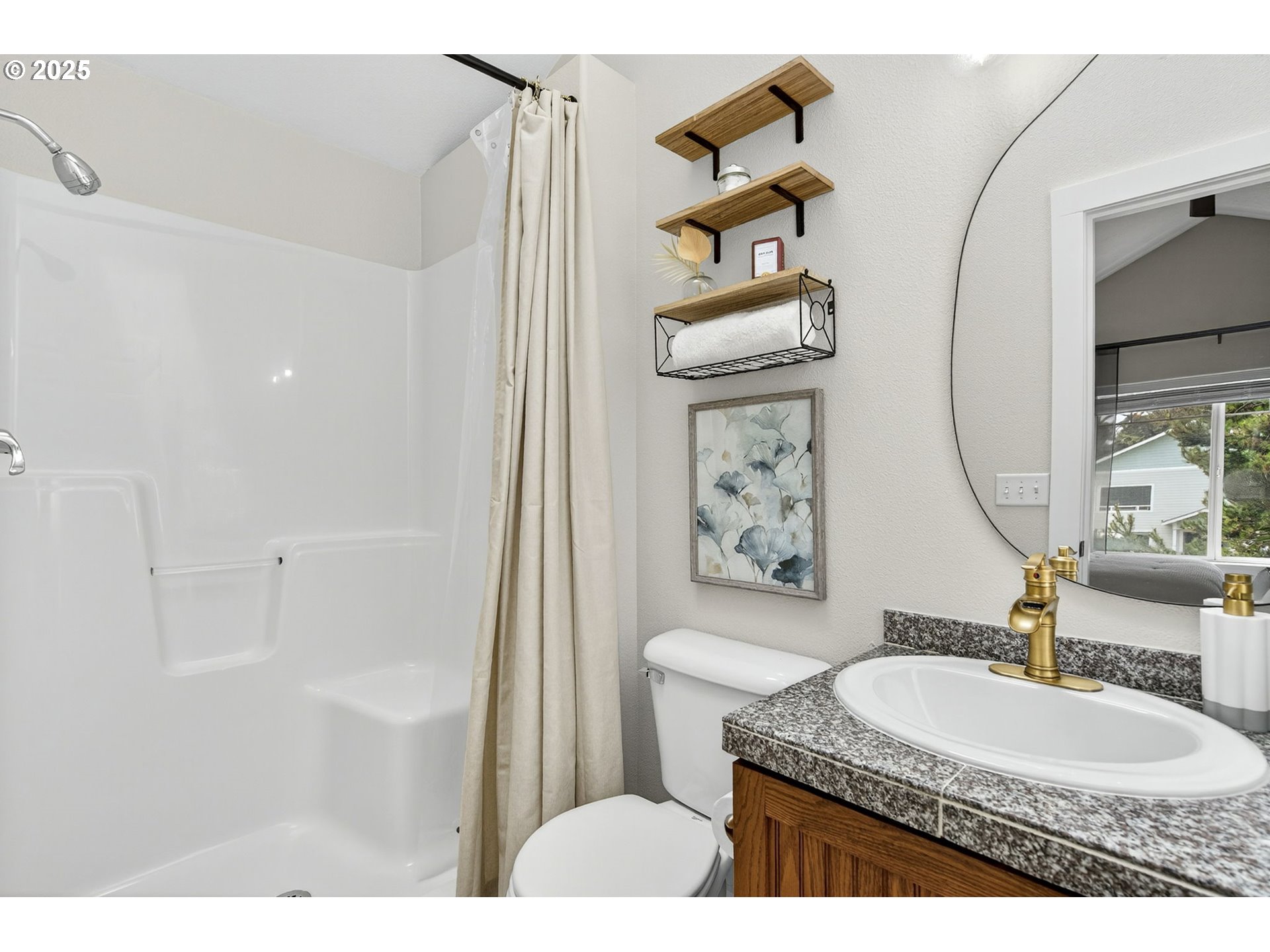 929 Northwest Spring Street Newport, OR 97365 - Photo 35 of 46 a bathroom with a granite countertop sink a toilet a mirror and shower