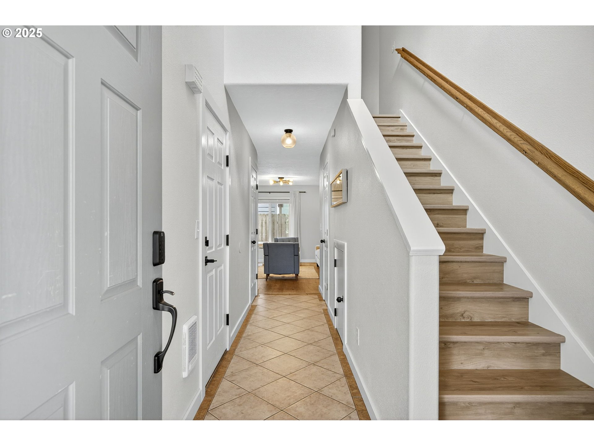 929 Northwest Spring Street Newport, OR 97365 - Photo 6 of 46 a view of a hallway with white walls and stairs