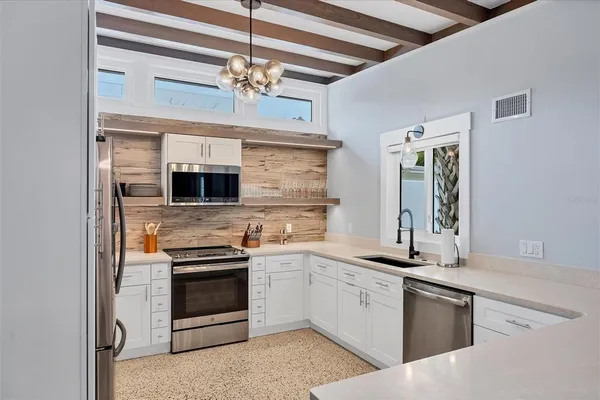 a kitchen with stainless steel appliances granite countertop a stove and a cabinets