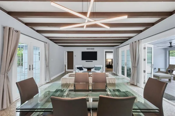 a room with stainless steel appliances furniture and a kitchen