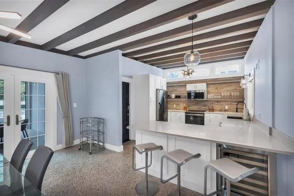 a bedroom with a large bed and a chandelier