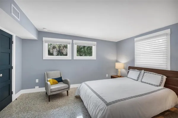 a bedroom with a bed and a table