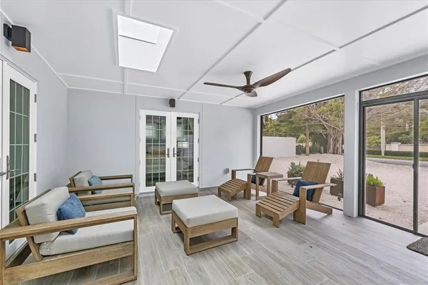 a living room with furniture and wooden floor