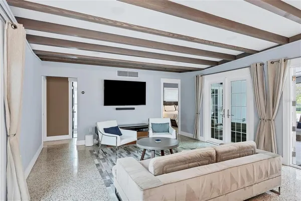 a living room with furniture and a flat screen tv