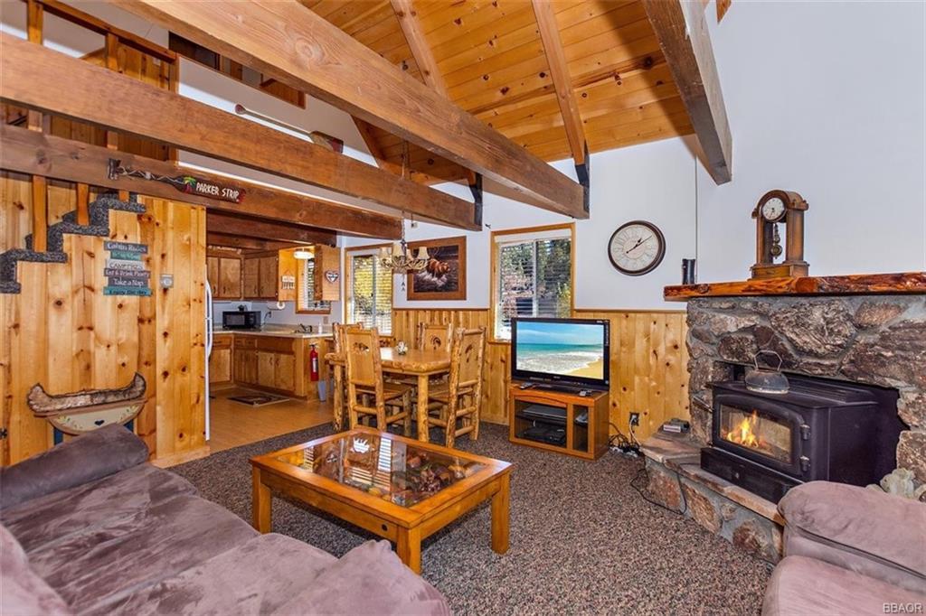 1082 Snow Ridge Road Big Bear City, CA 92314 - Photo 4 of 27 a living room with furniture a flat screen tv and a fireplace