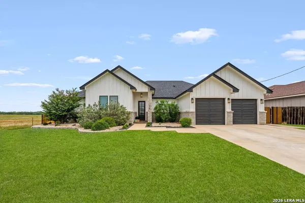 a front view of house with yard and green space