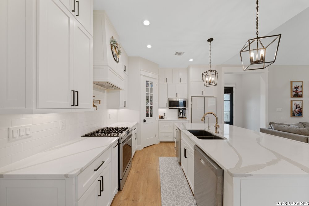 116 Park Heights Poth, TX 78147 - Photo 11 of 48 a kitchen with stainless steel appliances a stove sink and cabinets