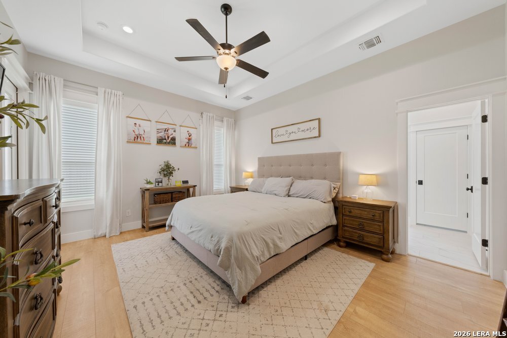 116 Park Heights Poth, TX 78147 - Photo 23 of 48 a bedroom with a large bed and a chandelier