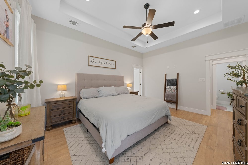 116 Park Heights Poth, TX 78147 - Photo 24 of 48 a bedroom with a bed and a chandelier