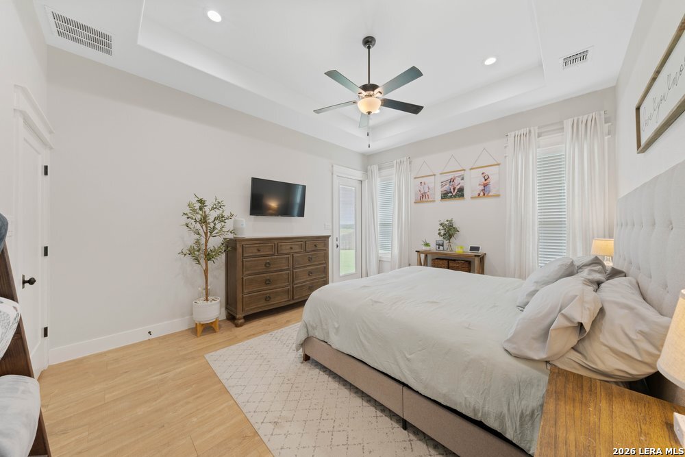 116 Park Heights Poth, TX 78147 - Photo 25 of 48 a bedroom with a bed and a chandelier