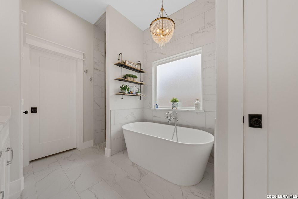 116 Park Heights Poth, TX 78147 - Photo 27 of 48 a spacious bathroom with a bathtub and sink